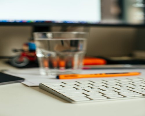 Water glass on desk showing daily hydration habit